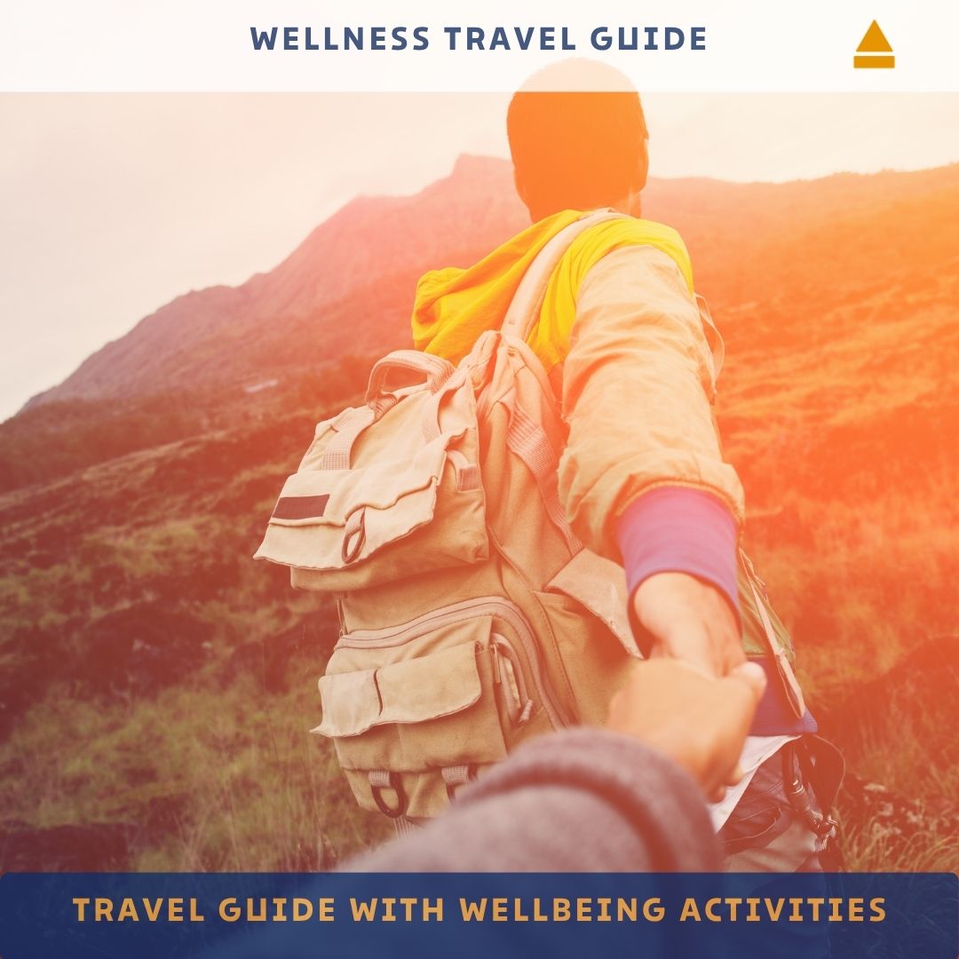 Person with a backpack holding hands with another person against a mountainous background, with 'Wellness Travel Guide' text at the top.